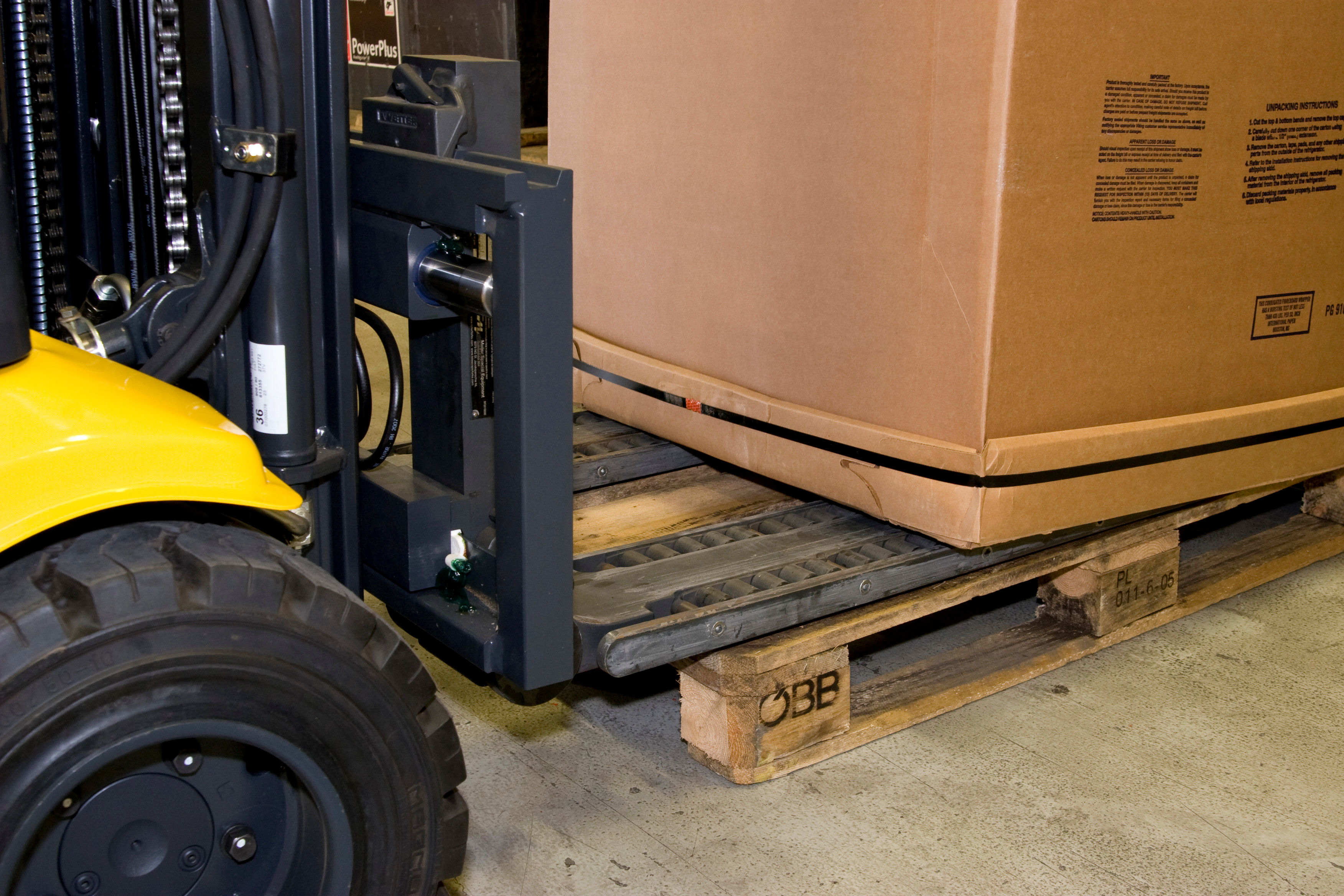 Forklift palletless handling attachment, RollerForks for slipsheets to handle corrugated boxes.