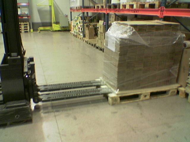 Forklift palletless handling attachment, RollerForks for slipsheets to handle corrugated boxes.