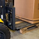 Forklift palletless handling attachment, RollerForks for slipsheets to handle corrugated boxes.