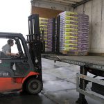 Hydraulically retractable and extendable forklift forks, KOOI-ReachForks, for save loading and unloading trucks with bagged goods.