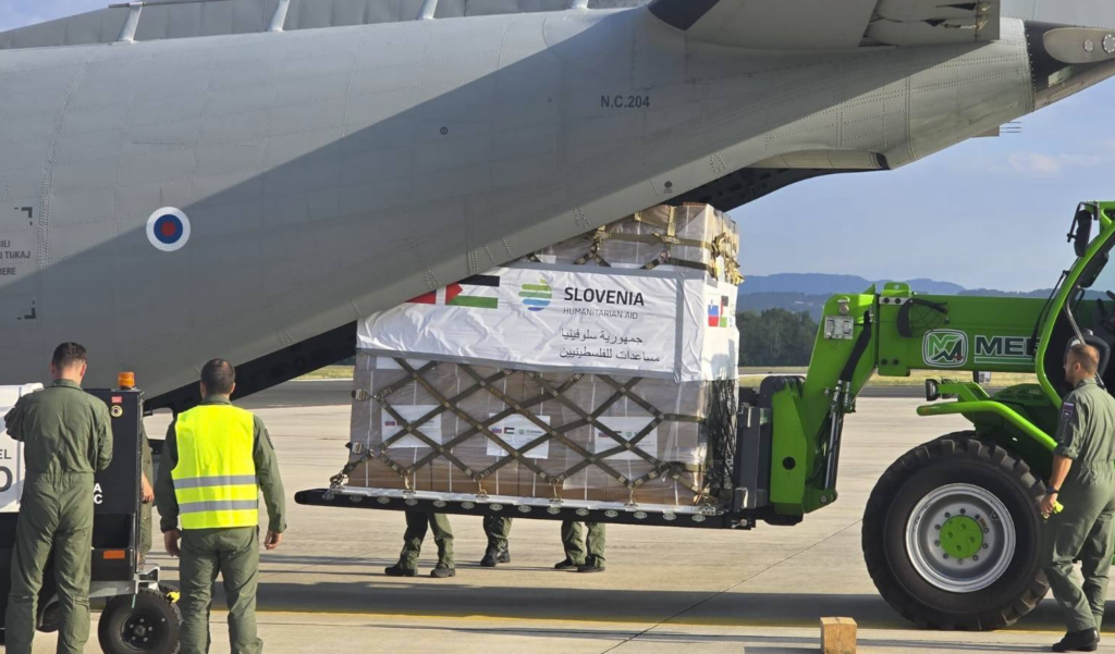 Humanitarian aid being loaded into aircraft using rollerized tine extenders